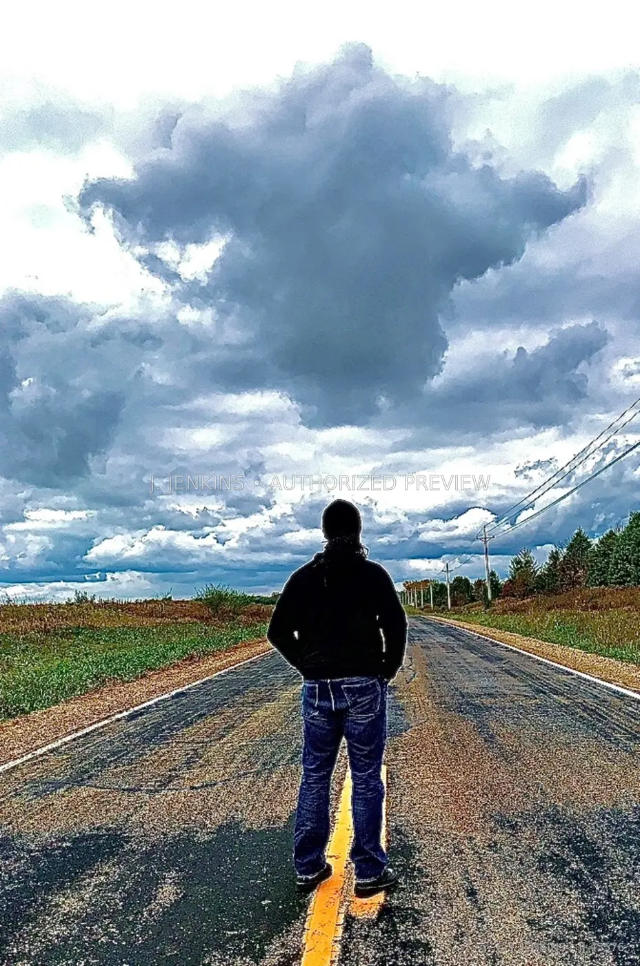 Figure standing on a rural centerline beneath monumental clouds