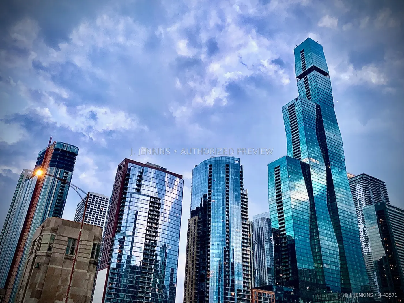 Modern glass towers under a blue evening sky