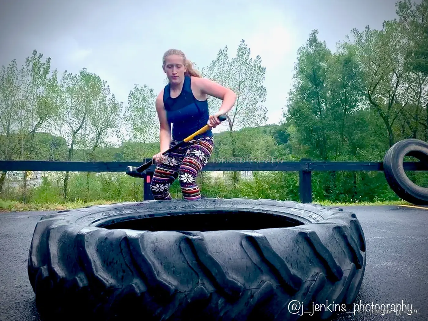 Athlete driving a sledgehammer into a training tire outdoors