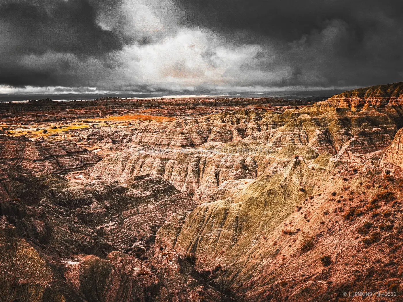 Wide Badlands panorama beneath a dark storm front
